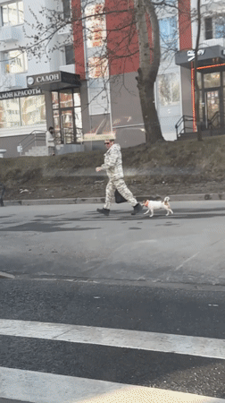 Man walks Jack Russell amid cloudy skies in Moscow