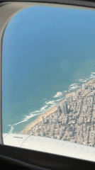 Aerial view captures Larnaca coastline from airplane window