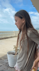Family gathering with dancing children captured on Sochi seaside patio