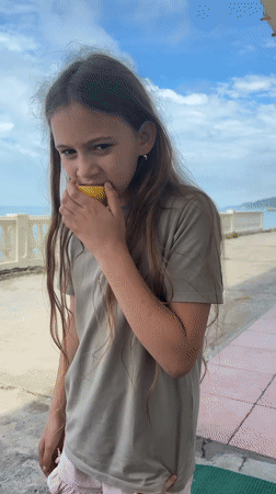 Family gathering with dancing children captured on Sochi seaside patio