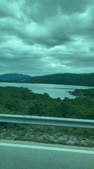 Overcast lake view captured from vehicle near Miločani, Montenegro