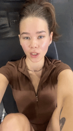 Woman exercises at leg press machine in Vietnamese gym