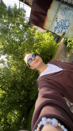 Woman films selfie video while walking in Perm, Russia