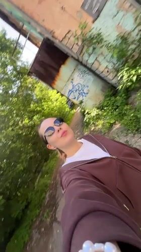 Woman films selfie video while walking in Perm, Russia