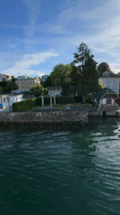 Boat passenger films scenic lakeside properties in Thalwil