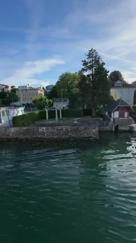 Boat passenger films scenic lakeside properties in Thalwil