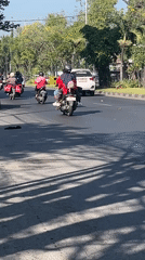 Busy morning traffic and roadside activity on Gelam's main street