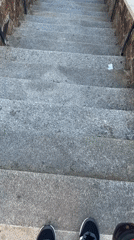Person walks through historic Stříbro streets, climbs stone stairs