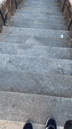 Person walks through historic Stříbro streets, climbs stone stairs