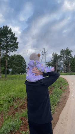 Family afternoon walk through a Russian village with a baby