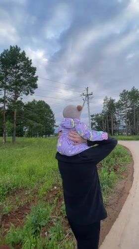 Family afternoon walk through a Russian village with a baby
