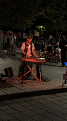Street keyboardist performing under red lights in Montreal