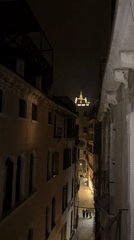 Nighttime Venice alley captured on video showing illuminated architecture