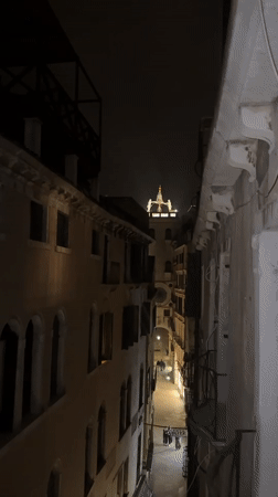 Nighttime Venice alley captured on video showing illuminated architecture