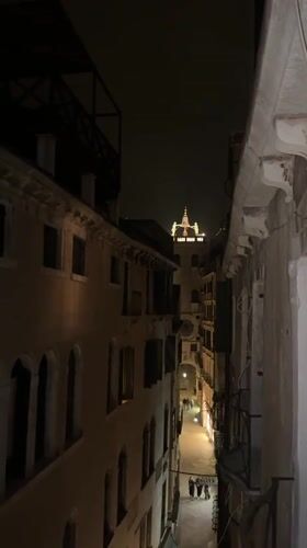 Nighttime Venice alley captured on video showing illuminated architecture