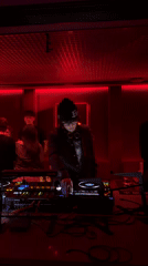 DJ performs with Pioneer setup in red-lit Hangzhou venue