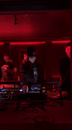 DJ performs with Pioneer setup in red-lit Hangzhou venue