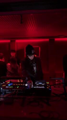 DJ performs with Pioneer setup in red-lit Hangzhou venue