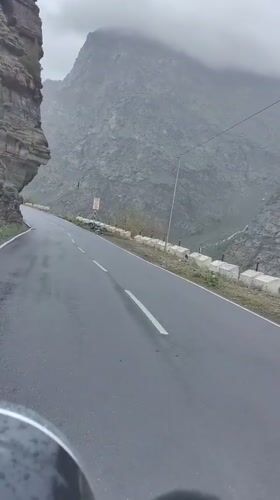 Wet mountain road through Gemur's rugged Himalayan terrain