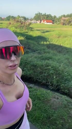 Woman films selfie video near Ubud rice fields
