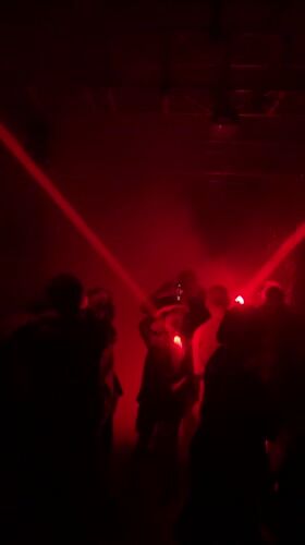 Industrial venue hosts gathering under red lights in Almaty