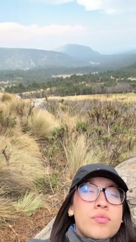 Woman rests on rock in mountainous Tlamacas area