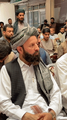 Formal gathering in Kandahar with speaker at podium