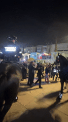 Mounted police patrol crowds in Tel Aviv at night