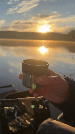 Early morning fishing session captures peaceful lakeside sunrise moment
