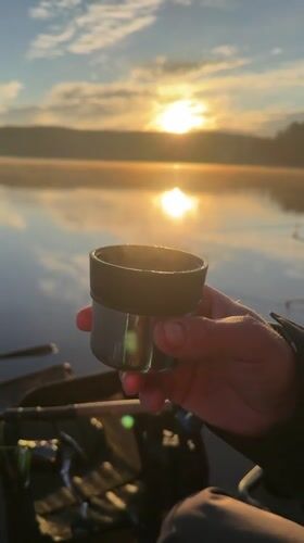 Early morning fishing session captures peaceful lakeside sunrise moment