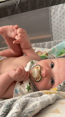 Baby with pacifier observed during early morning care routine