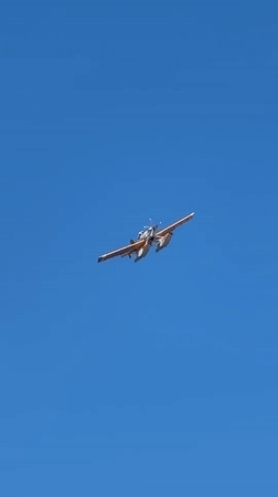 Orange and white seaplane lifting off near Fethiye coast