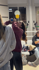 Woman finishes drink from plastic container in Adler
