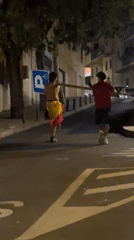 Carrying a wooden pole through El Escorial streets at night