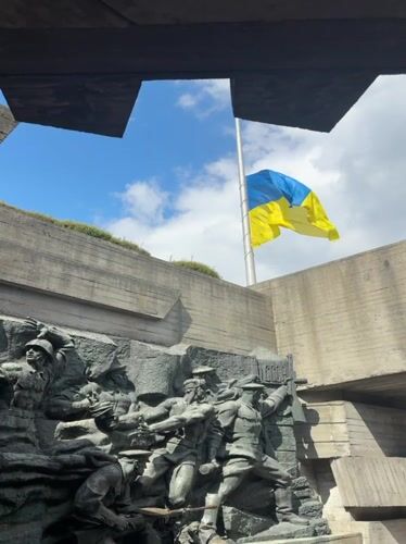Ukrainian flag at half-mast over military monument in Kyiv