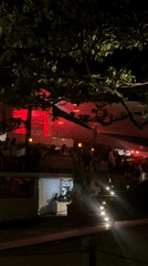 Man waves red fan in North Kuta nightclub