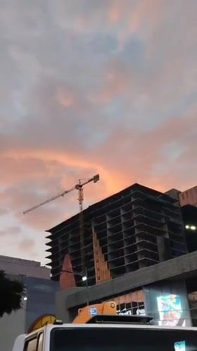 Construction site with crane observed during sunset in Caracas