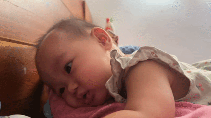 Baby resting on a pink pillow in West Jakarta