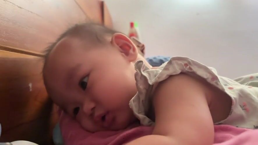 Baby resting on a pink pillow in West Jakarta