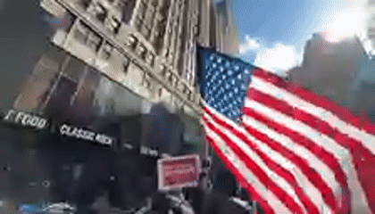 Political protest marches through Times Square with anti-Trump signs