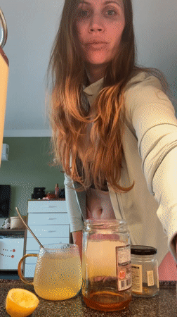 Woman applies kinesiology tape to face in Turkey bathroom