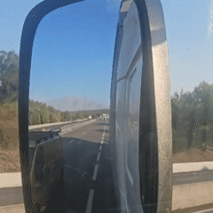 Highway drive through Provence, side mirror catching trailing traffic