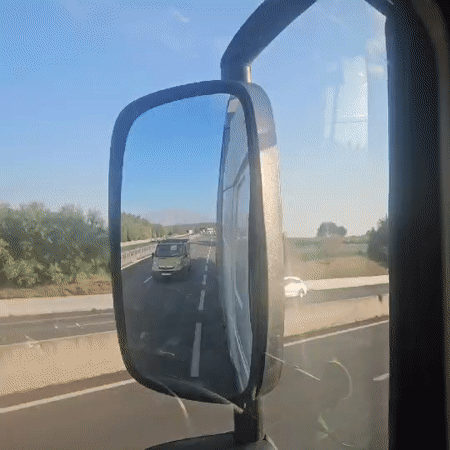 Highway drive through Provence, side mirror catching trailing traffic