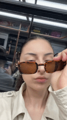 Woman puts on sunglasses aboard Moscow train