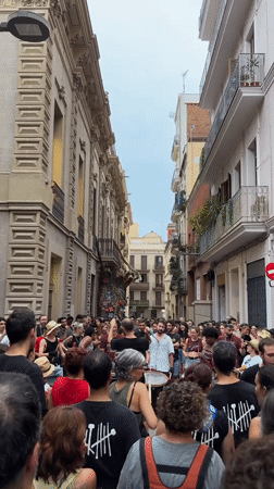 Drumming and dancing in a packed Barcelona street