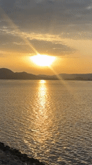 Golden sunrise reflected over still waters near Dam Camp