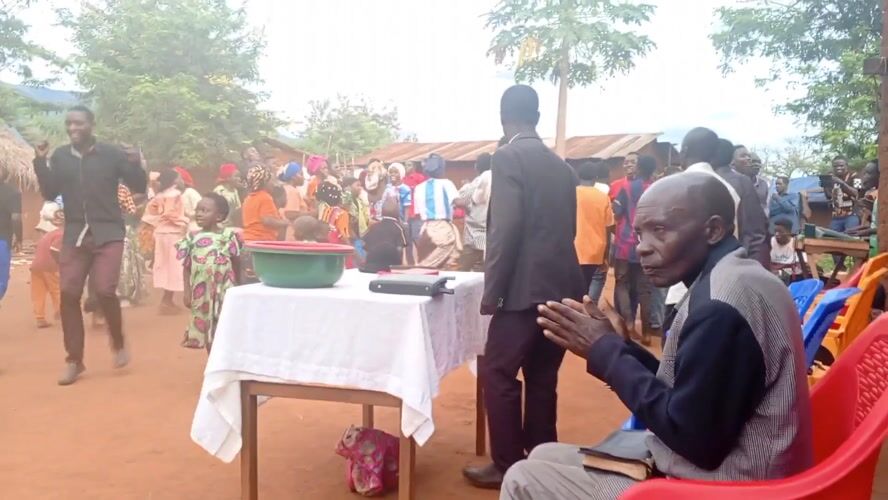 Elderly man dances barefoot in rural Congo village