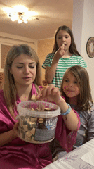 Woman shares snacks with two girls at Budva home