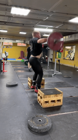 Weightlifter trains on stacked pallets in Blagoveshchensk gymnasium
