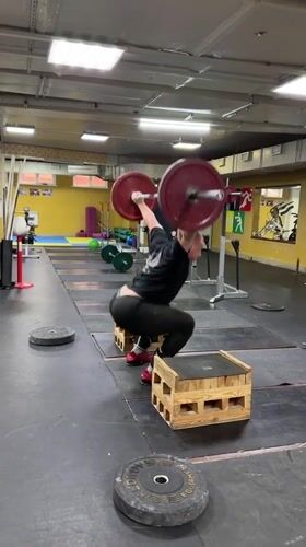 Weightlifter trains on stacked pallets in Blagoveshchensk gymnasium